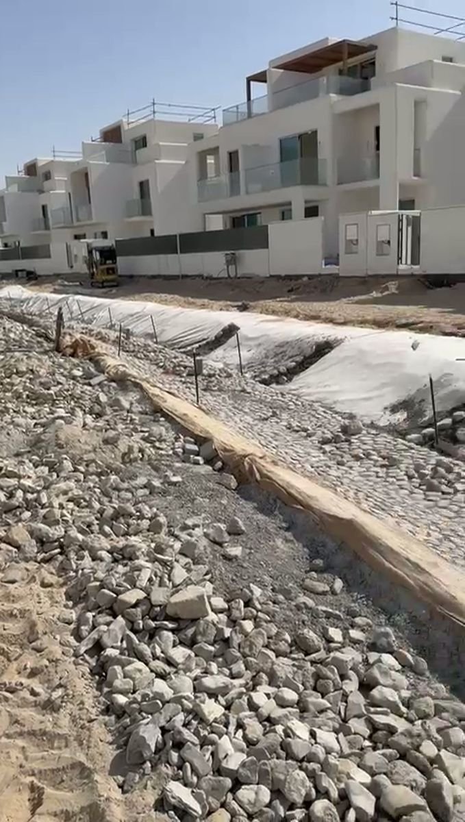 Geotextile-lined drainage channel with stone pitching — Dubai villa project